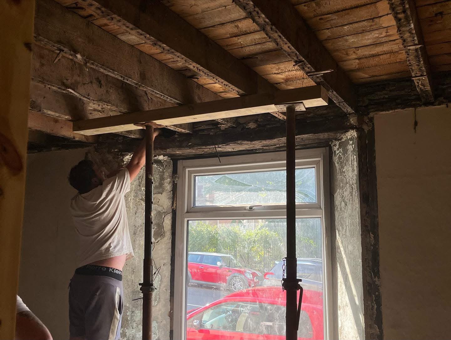 New steel lintel being set into a masonry opening on an HMO conversion