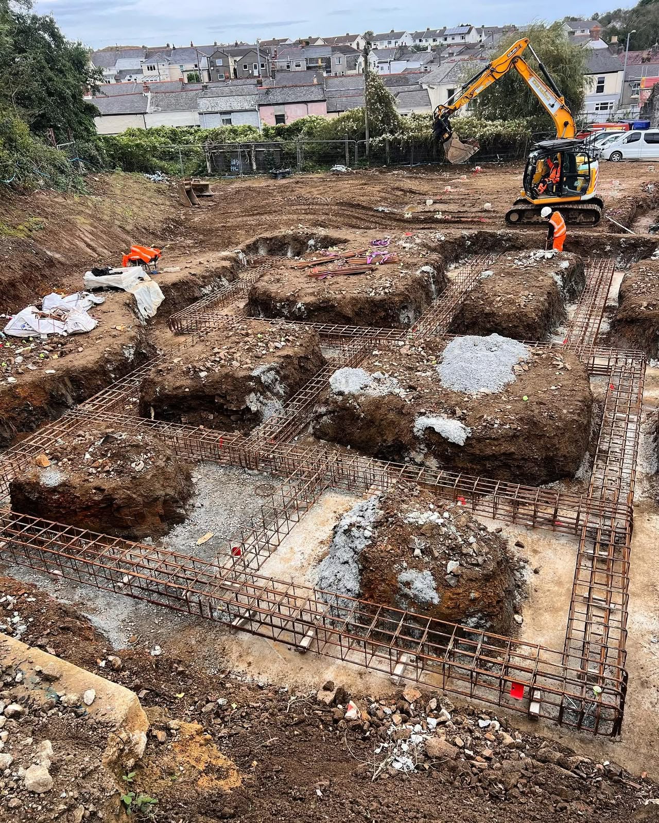 Excavator working on piled foundations at a Camborne construction site