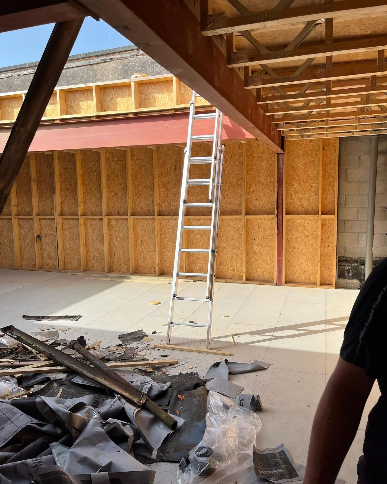 OSB deck laid across flat roof joists on a commercial building