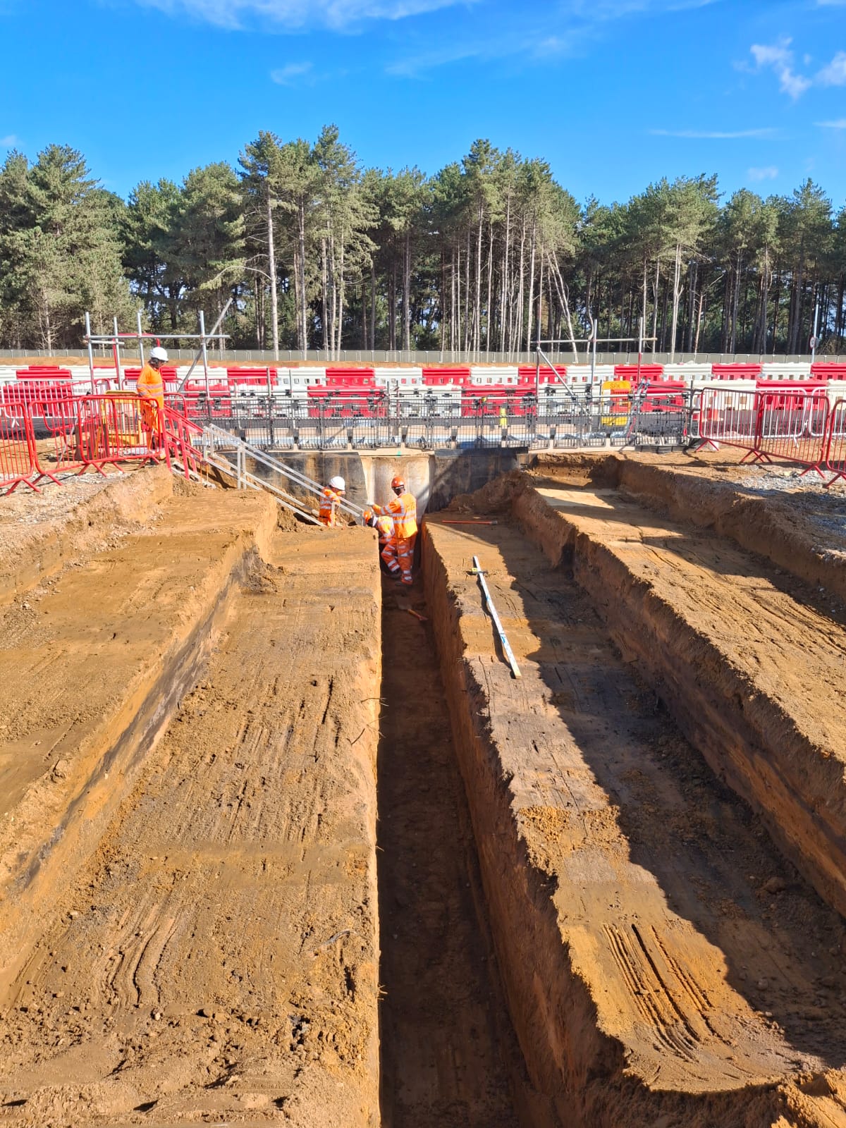 Drainage pipe run bedded and ready for backfill on a deep drainage project
