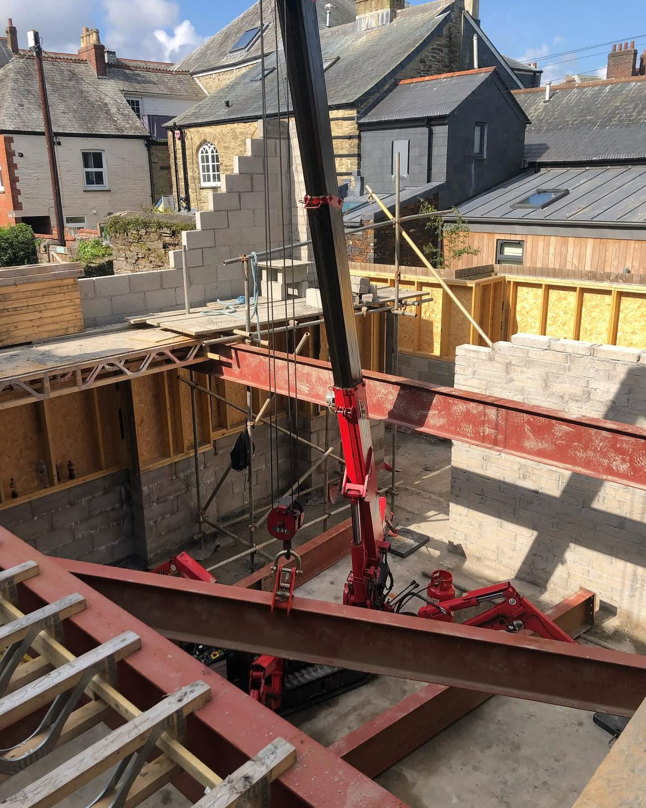 Spider crane positioned inside a commercial refurbishment while setting structural steels